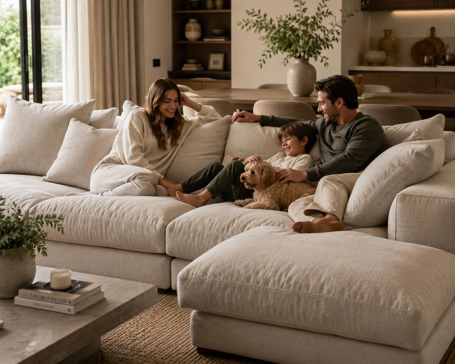 Family relaxing on a luxury feather sofa